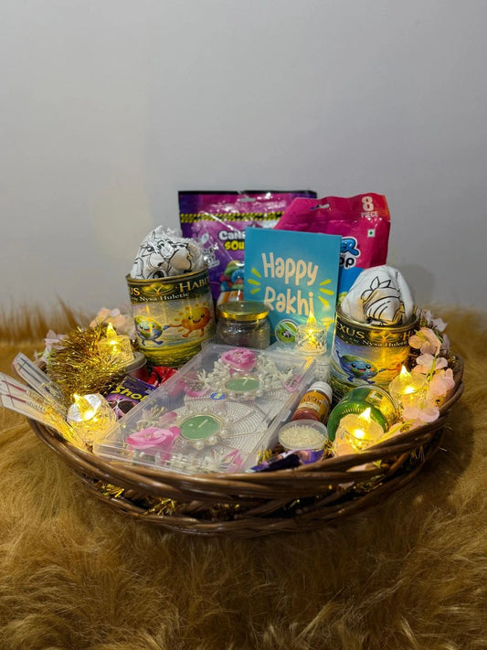 Rakhi gift hamper featuring two Sun Activated Colour-Changing T-Shirts, greeting card, chocolates, Rakhis, and festive essentials.