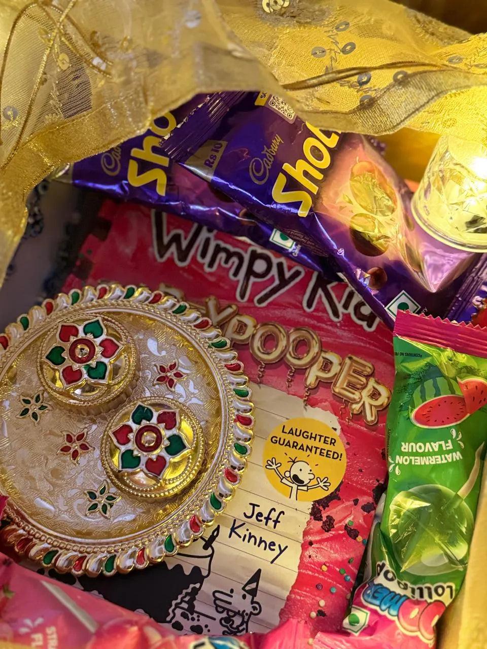 Sun Activated Colour-Changing Kids T-Shirt packed in a reusable tin inside the Book Lover Rakhi Gift Hamper.