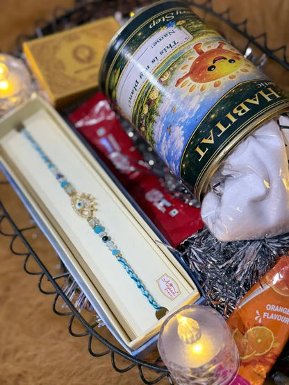 Close-up of the Classic Rakhi Gift Hamper with Evil Eye Crown Rakhi, Sun Activated Kids T-Shirt, KitKat chocolates, and festive essentials.