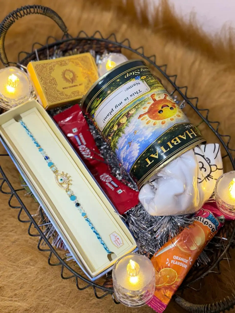 Complete Classic Raksha Bandhan gift hamper featuring one Sun Activated Colour-Changing Kids T-Shirt, Evil Eye Crown Rakhi, chocolates, lollipop, and Roli Chawal set.
