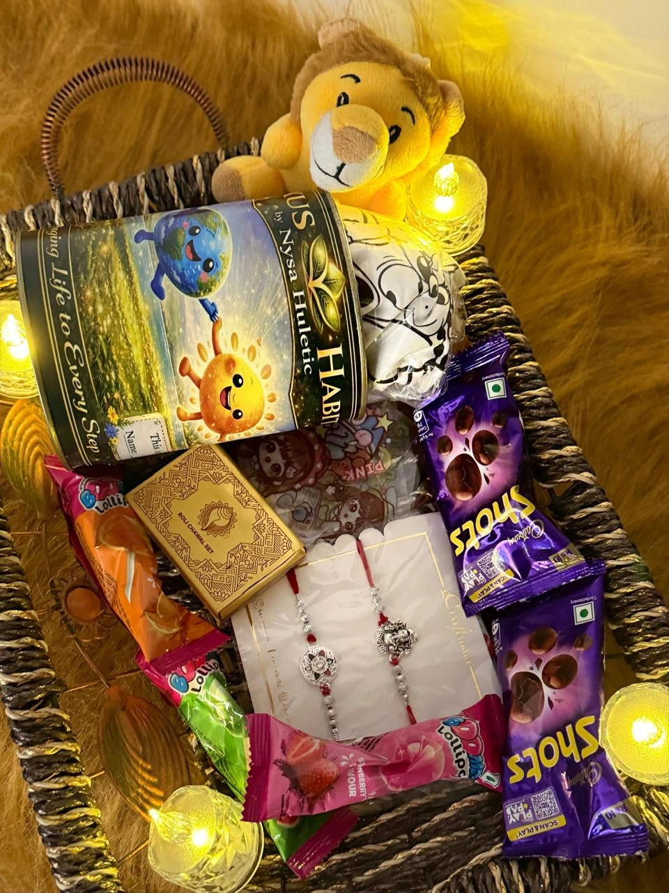 Classic Raksha Bandhan gift hamper beautifully arranged with a Sun Activated Colour-Changing Kids T-Shirt, premium Rakhi, chocolates, and festive accessories.