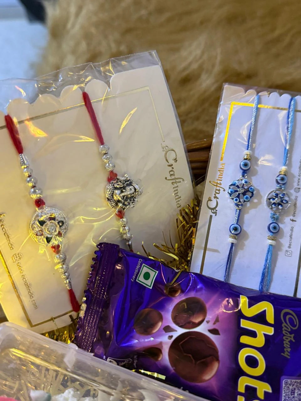 Designer Rakhi sets included in the Sun Activated Raksha Bandhan gift hamper for kids.