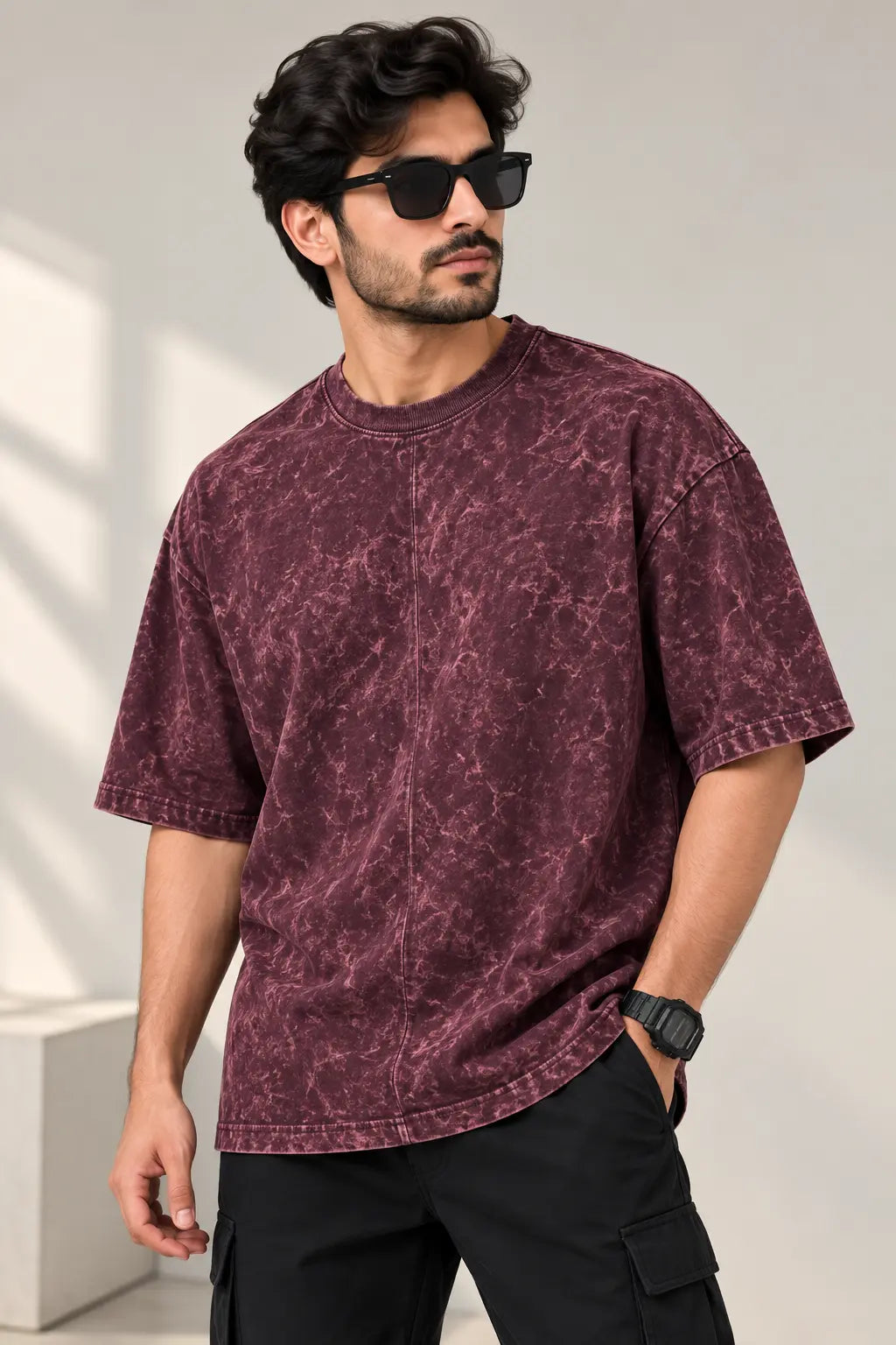 Men's maroon acid wash oversized t-shirt with marbled wash finish, styled with black cargo pants