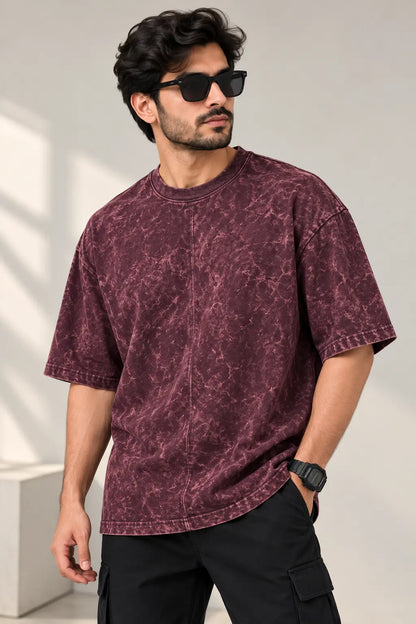 Men's maroon acid wash oversized t-shirt with marbled wash finish, styled with black cargo pants