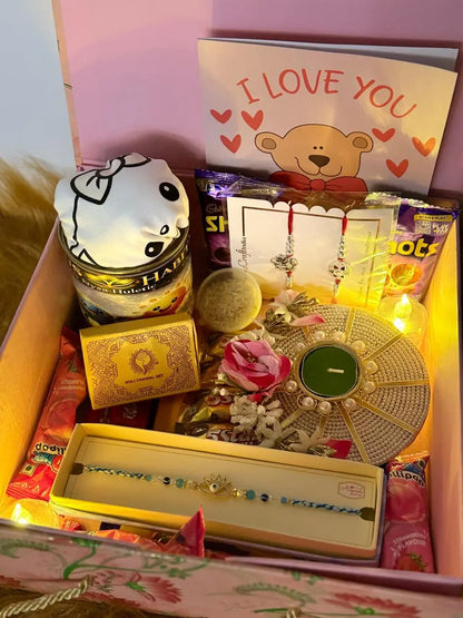Premium Raksha Bandhan gift box for kids with one Sun Activated Colour-Changing T-Shirt, Rakhi, chocolates, greeting card, and festive decorations.