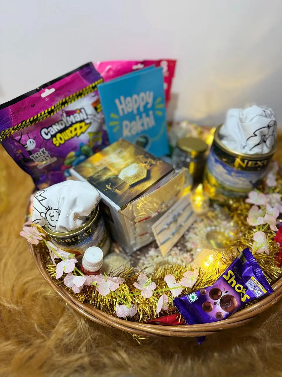 Complete Ultimate Rakhi Celebration Hamper featuring twin Sun Activated Kids T-Shirts, designer Rakhis, chocolates, decorative night lamp, surprise necklace, and festive gift accessories.