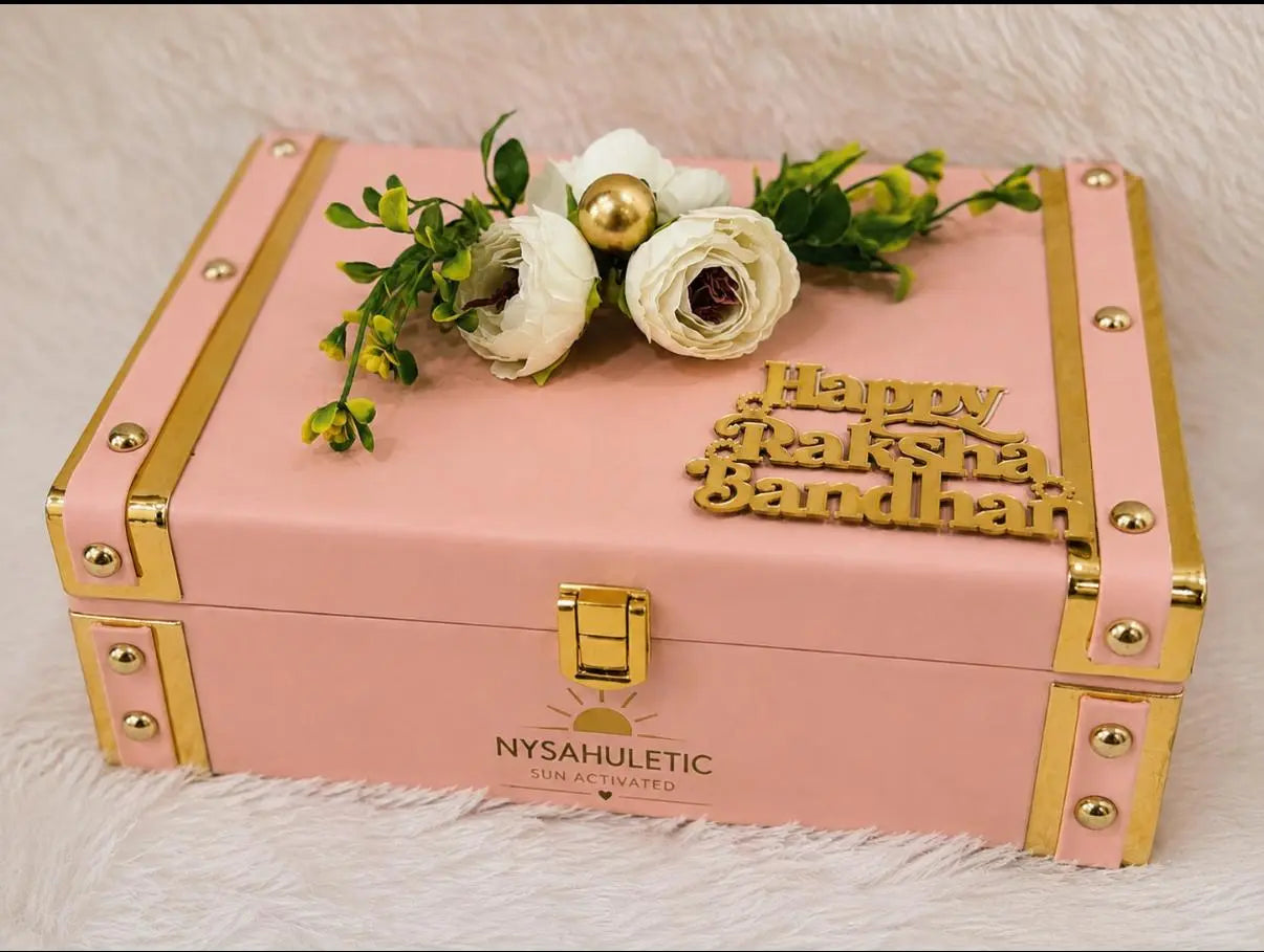 Premium Rakhi Keepsake Gift Box featuring one Sun Activated Colour-Changing Kids T-Shirt, Evil Eye bracelet, star pendant necklace, ring, hair clutch, cashew nuts, KitKat, and decorative keepsake box by Nysa Huletic.