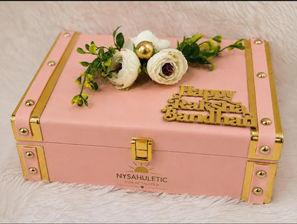 Premium Rakhi Keepsake Gift Box featuring one Sun Activated Colour-Changing Kids T-Shirt, Evil Eye bracelet, star pendant necklace, ring, hair clutch, cashew nuts, KitKat, and decorative keepsake box by Nysa Huletic.