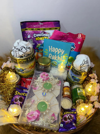Complete Raksha Bandhan gift basket with Sun Activated T-Shirts, candies, chocolates, Rakhis, diyas, and festive decorations.