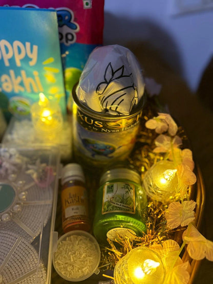 Reusable tin containing a Sun Activated Colour-Changing cotton T-Shirt inside the Rakhi gift hamper.