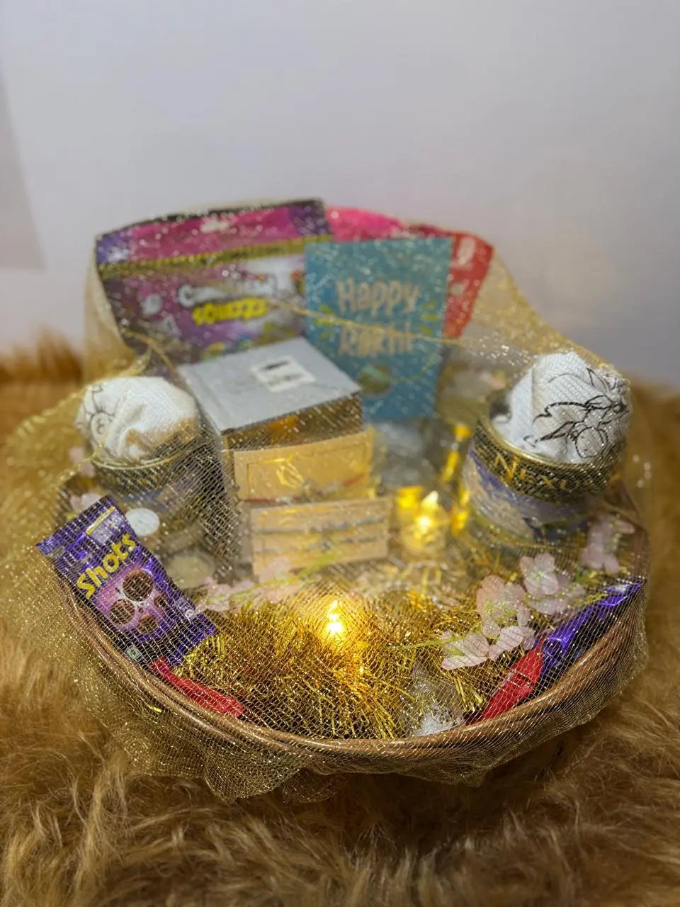 Covered Ultimate Rakhi Celebration Hamper with twin Sun Activated Kids T-Shirts, chocolates, festive decorations, and premium gift packaging.