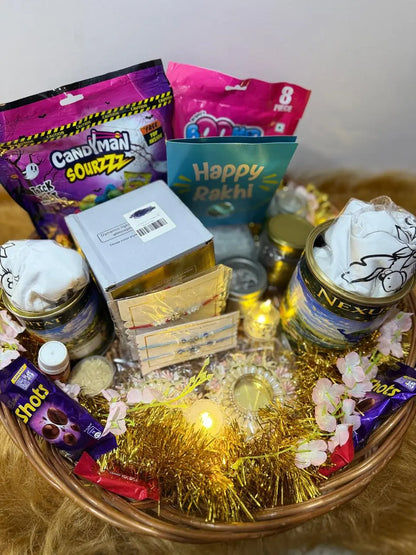 Open Ultimate Rakhi Celebration Hamper featuring 2 Sun Activated Colour-Changing Kids T-Shirts, designer Rakhis, chocolates, night lamp, surprise necklace, and festive accessories.